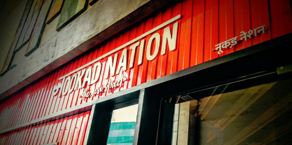 Interior menu system installed — hanging station boards in the Nookad Nation street-food style.